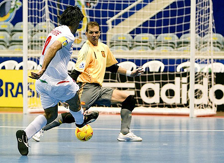 Iran's futsal player Vahid Shamsaee (L) kicks to score his goal against Spain's goalkeeper Luis Amado, on October 1, 2008 during a qualifying game valid for the FIFA Futsal World Cup in Rio de Janeiro, Brazil. 
